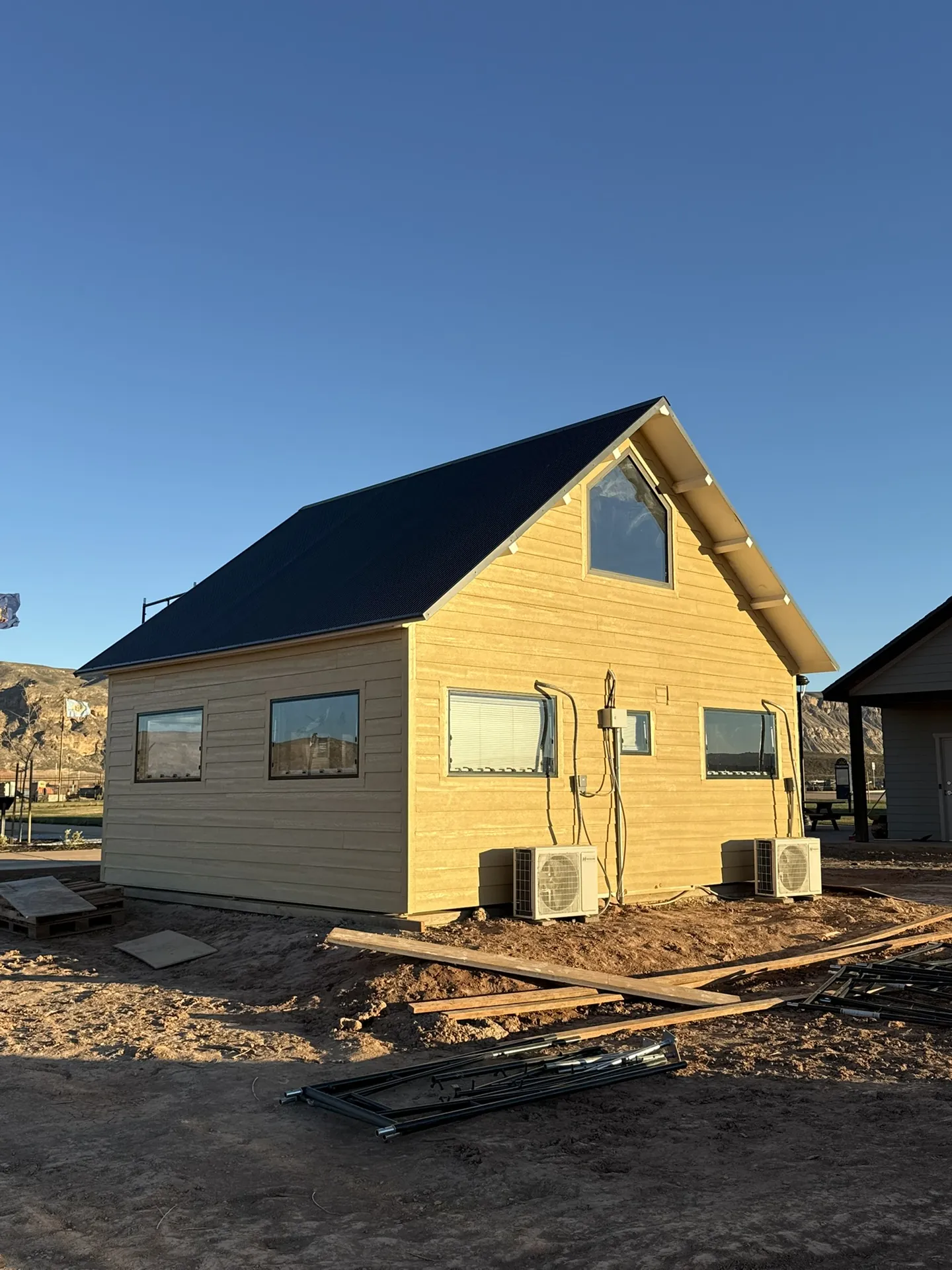 Completed Boxabl siding project at Liberty Village in Hurricane, Utah at golden hour with mountains behind